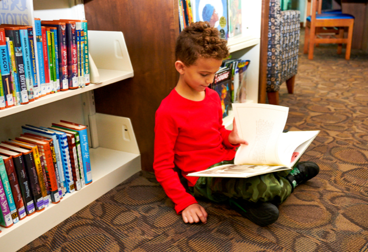 Boy reading in library